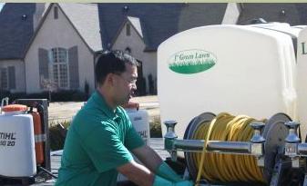 1st Green Lawn technician applying treatment from a branded spray rig in Bentonville, AR